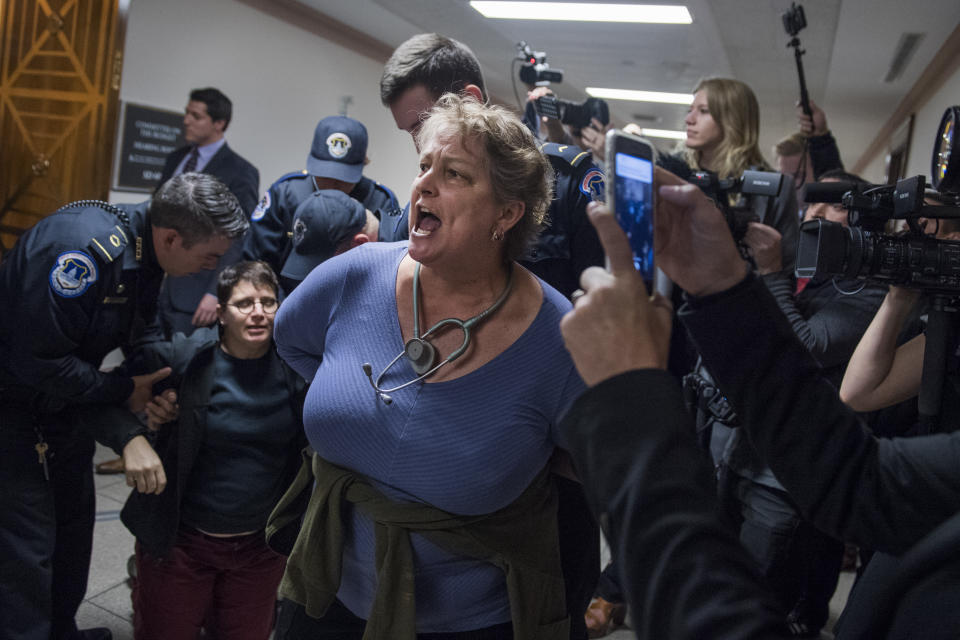 <p>Protesters disrupt the Senate Budget Committee markup of the tax reform bill in Dirksen Building on Nov. 28, 2017. (Photo: Tom Williams/CQ Roll Call/Getty Images) </p>