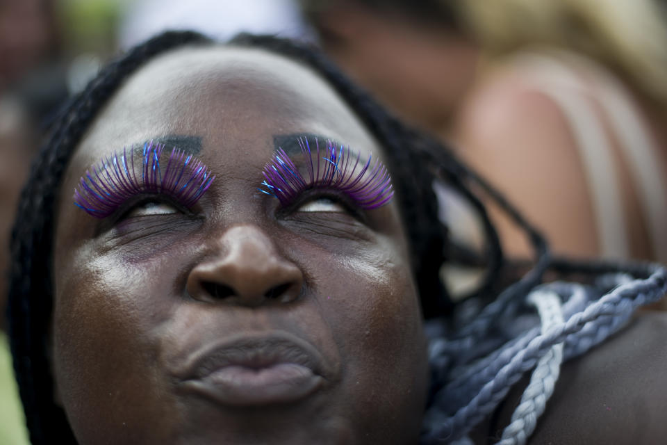 A reveler shows her false eyelashes during the "Bloco da Favorita" street party on Copacabana beach, Rio de Janeiro, Brazil, Sunday, Jan. 12, 2020. Copacabana beach hosted the kick-off to the 50-day Countdown to Carnival with a concert and the "election" of King Momo to preside over festivities. (AP Photo/Bruna Prado)