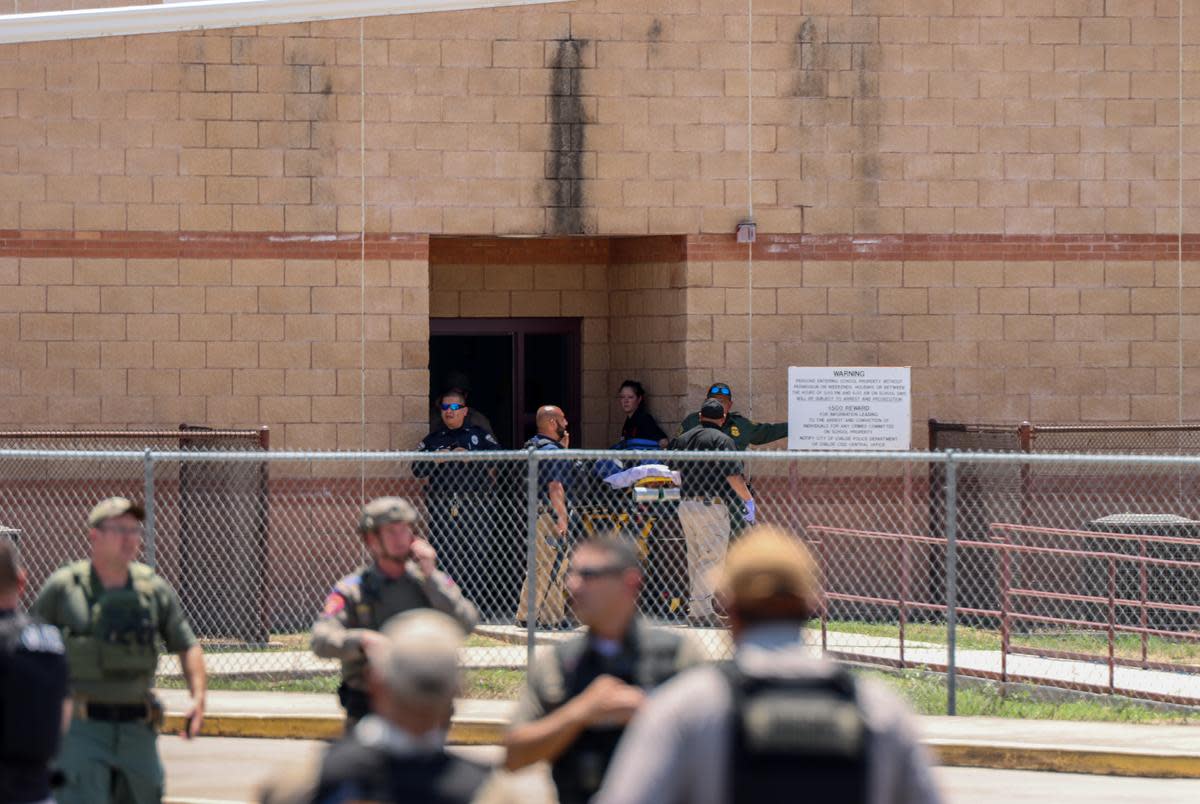 Authorities gather outside of Robb Elementary School in Uvalde after a gunman entered and killed 19 students and two teachers on May 24, 2022.