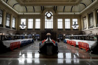 Tarps and fences block the seating area in the Hoboken Terminal waiting room in Hoboken, N.J., Tuesday, Oct. 27, 2020. Once a gleaming symbol of early 20th-century ambition and prosperity, the grand rail terminal now sits as a somber reminder of the daunting challenges facing mass transit in the New York region. (AP Photo/Seth Wenig)