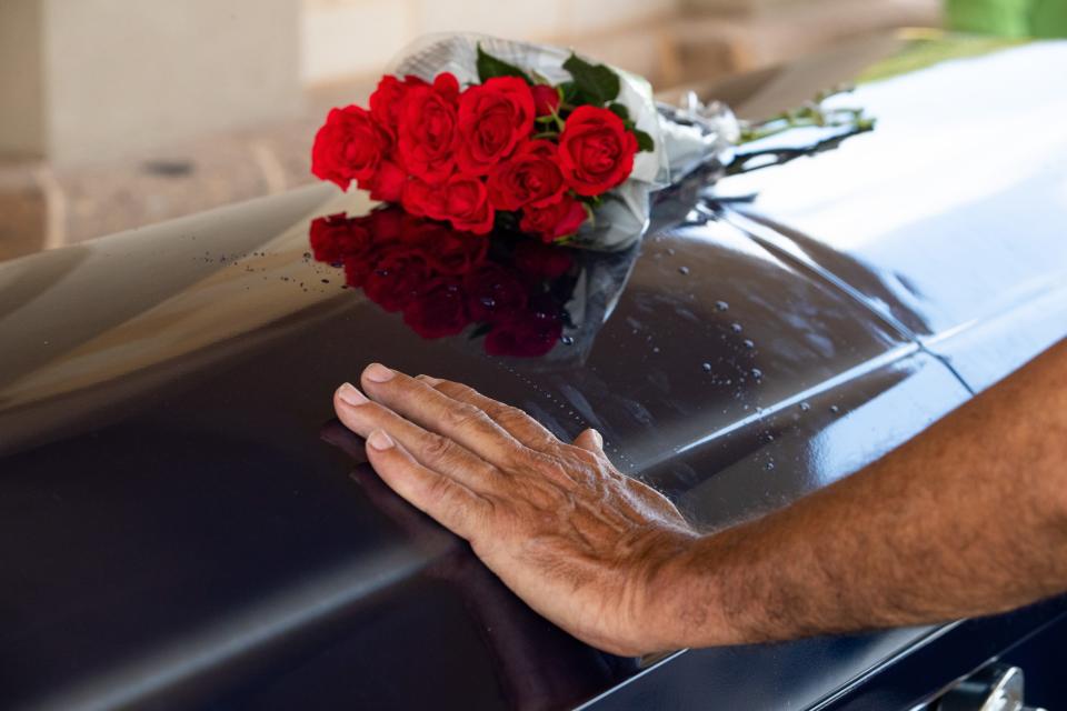 A woman pays her respects to Pfc. William Conely Carroll Jr. during his funeral at the Coastal Bend Texas State Veterans Cemetery on Wednesday, Aug. 21, 2019.