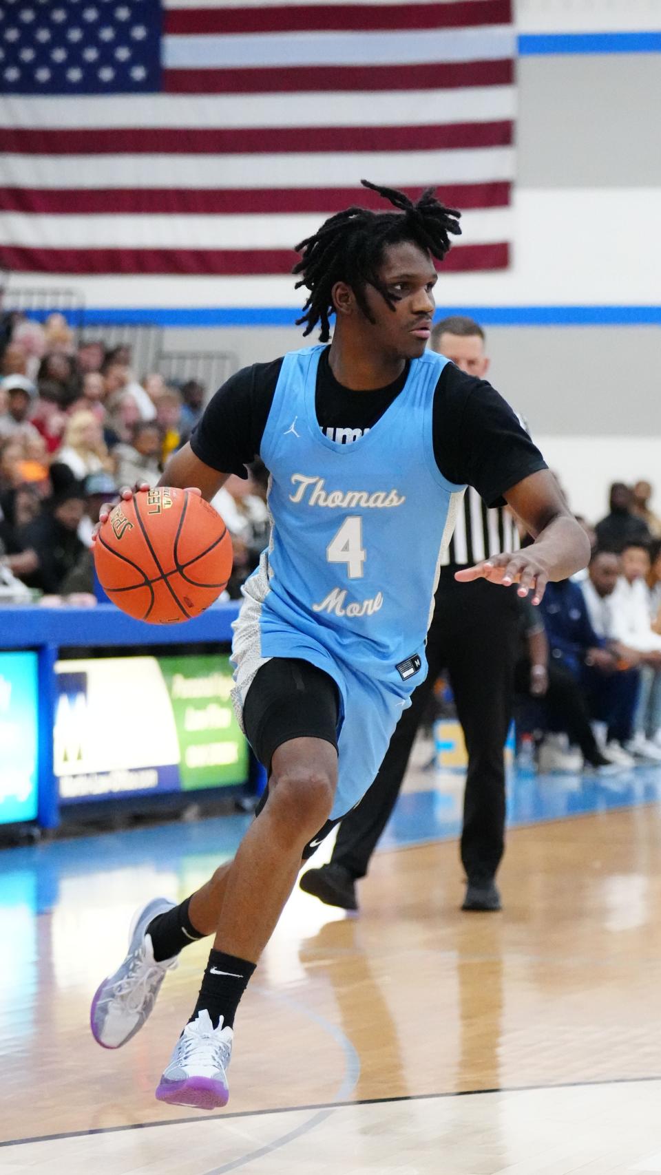 St. Thomas More's Amari McCottry (4) breaks for the paint during the WIAA D3 boys basketball sectional semifinal against Milwaukee Academy of Science at Oak Creek High School on Thursday, March 7, 2024.