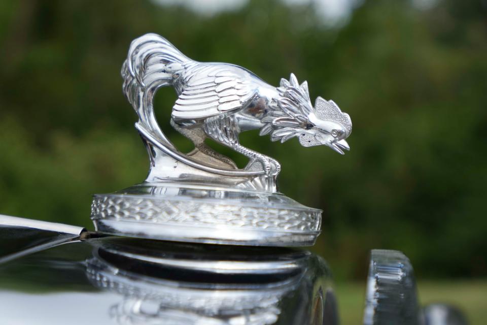 A feisty bantam rooster is ready for action atop of the radiator cap of Robert Cunningham's 1932 American Austin Bantam roadster.