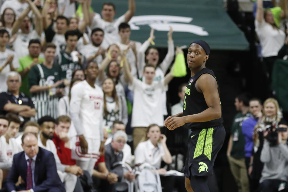 Fans cheer after Michigan State guard Cassius Winston attained the all-time Big Ten and Michigan State records for assists during the second half of an NCAA college basketball game against Wisconsin, Friday, Jan. 17, 2020, in East Lansing, Mich. (AP Photo/Carlos Osorio)