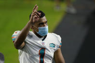 Miami Dolphins quarterback Tua Tagovailoa (1) gesture as he leaves the field at the end of an NFL football game against the Los Angeles Chargers, Sunday, Nov. 15, 2020, in Miami Gardens, Fla. The Dolphins defeated the Chargers 29-21. (AP Photo/Lynne Sladky)