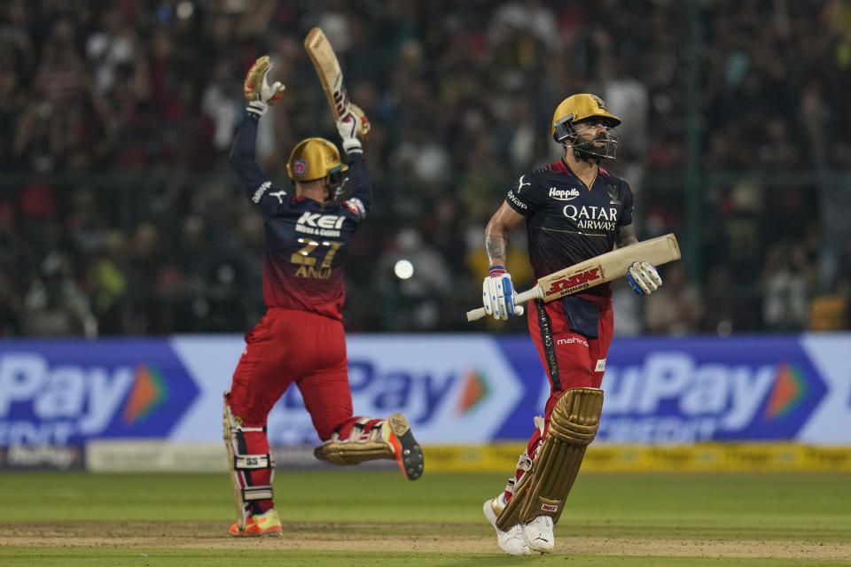 Royal Challengers Bangalore's Anuj Rawat reacts as his teammate Virat Kohli, right, finishes his century during the Indian Premier League cricket match between Royal Challengers Bangalore and Gujarat Titans in Bengaluru, India, Sunday, May 21, 2023. (AP Photo /Aijaz Rahi)