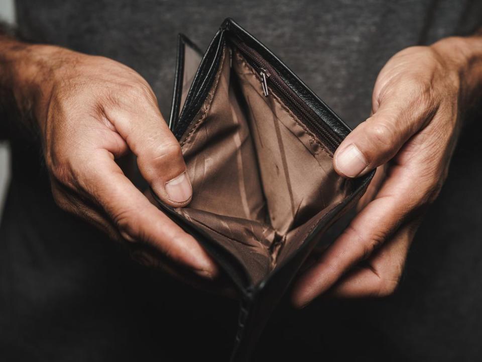 Close up of man hands holding and empty wallet. financial crisis, bankruptcy, no money, bad economy Concept.