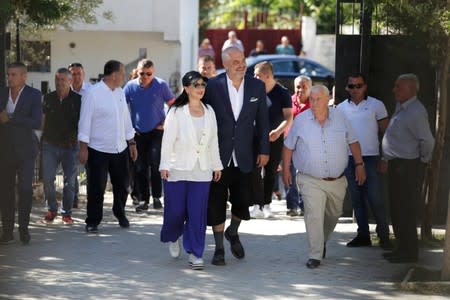 Albania's Prime Minister Edi Rama and his wife Linda Rama arrive at the polling station near Tirana