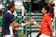 Tennis - ATP 1000 - Monte Carlo Masters - Monte-Carlo Country Club, Roquebrune-Cap-Martin, France - April 19, 2019 Russia's Daniil Medvedev with Serbia's Novak Djokovic after winning their quarter final match REUTERS/Eric Gaillard