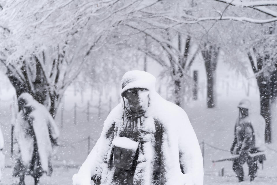 Snow blankets the statues of soldiers in the the Korean War Veterans Memorial, Monday, Jan. 3, 2022, in Washington. (AP Photo/Alex Brandon)