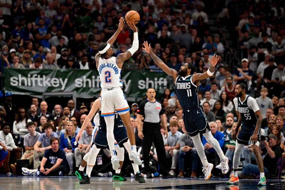 May 13, 2024; Dallas, Texas, USA; Oklahoma City Thunder guard Shai Gilgeous-Alexander (2) makes a jump shot over Dallas Mavericks guard Kyrie Irving (11) during the second half in game four of the second round for the 2024 NBA playoffs at American Airlines Center.