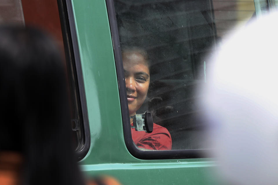 NagaWorld's union leader Chhim Sithar sits in a prisoner van in front of Phnom Penh Municipal Court in Phnom Penh, Cambodia, Thursday, May 25, 2023. Chhim Sithar who led a long-running strike against Cambodia’s biggest casino was sentenced Thursday to two years in prison for incitement to commit a felony, while eight fellow union members received lesser terms that do not include time behind bars. (AP Photo/Heng Sinith)