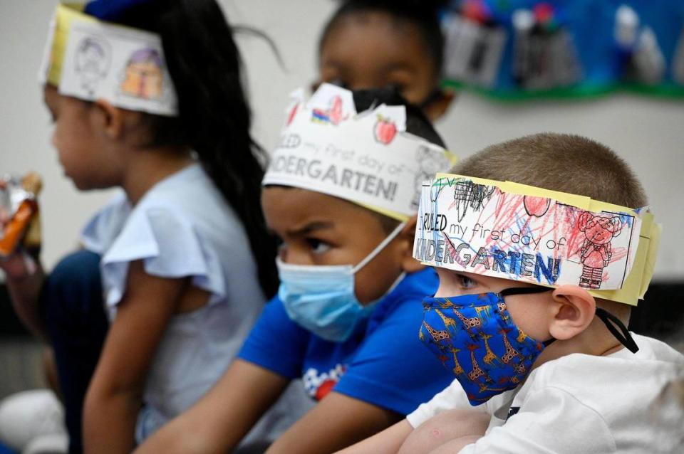 Kindergarten students listen to their teacher at Hazel Grove Elementary School in Kansas City, Kansas. The district shut down schools earlier this week due to a severe staff shortage and COVID-19 outbreaks.