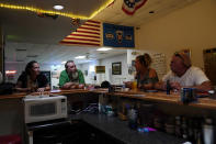Patrons talks to each other at the bar in the Veterans of Foreign Wars building in Desert Shores, Calif., Wednesday, July 14, 2021. The area around the nearby Salton Sea, California's largest but rapidly shrinking lake, is at the forefront of efforts to make the U.S. a major global producer of lithium, the ultralight metal used in rechargeable batteries. But decades of economic stagnation and environmental ruin have left some nearby residents indifferent or wary. (AP Photo/Marcio Jose Sanchez)