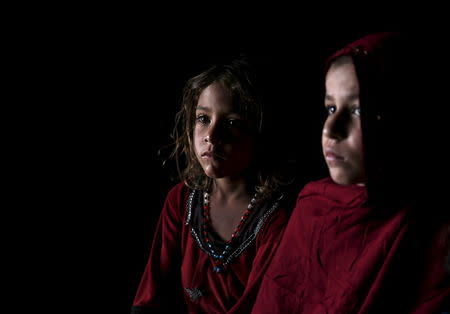 Afghan refugee children, returning from Pakistan, watch a short video clip about mines at a mines and explosives awareness program at a United Nations High Commissioner for Refugees (UNHCR) registration centre in Kabul, Afghanistan September 2, 2015. A growing number of Afghan refugees are making the journey back from Pakistan with trepidation, as militant violence intensifies, yet feeling shunned by their adopted country as relations between the neighbours sour. The rate of returnees has more than quadrupled this year, with 137,000 refugees going back to Afghanistan since January. REUTERS/Ahmad Masood