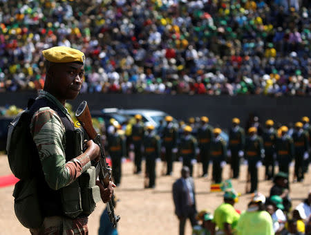 An armed soldier stand as Zimbabwe's President Elect Emmerson Mnangagwa addresses the people gathered at the national 38th Heroes Day Commemorations at the Heroes Acre in Harare, Zimbabwe, August 13,2018. REUTERS/Philimon Bulawayo