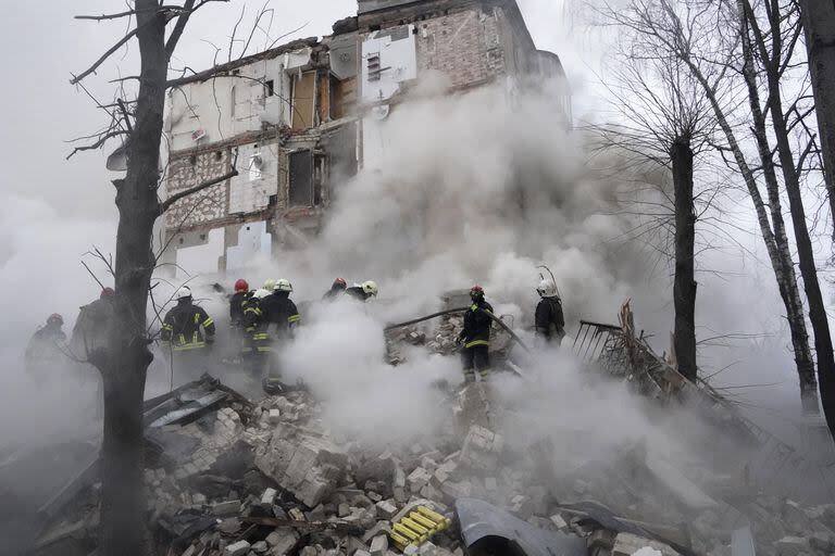 Los rescatistas buscan víctimas en un edificio atacado por bombas rusas en Kharkiv (AP Photo/Andrii Marienko)