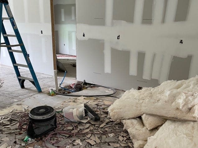 A house with its floor being gutted.