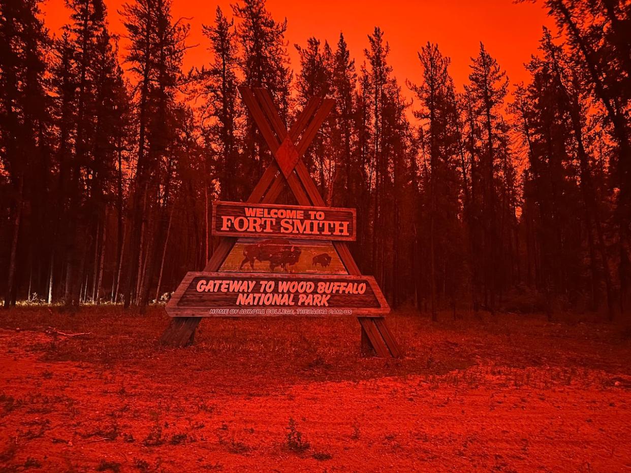 A photo Fort Smith Sunday night shows red skies. An evacuation order was issued on Saturday for Fort Smith, Salt River First Nation and Smith's Landing First Nation as a wildfire in Wood Buffalo National Park threatens Highway 5. (Julie Beaver/CBC - image credit)