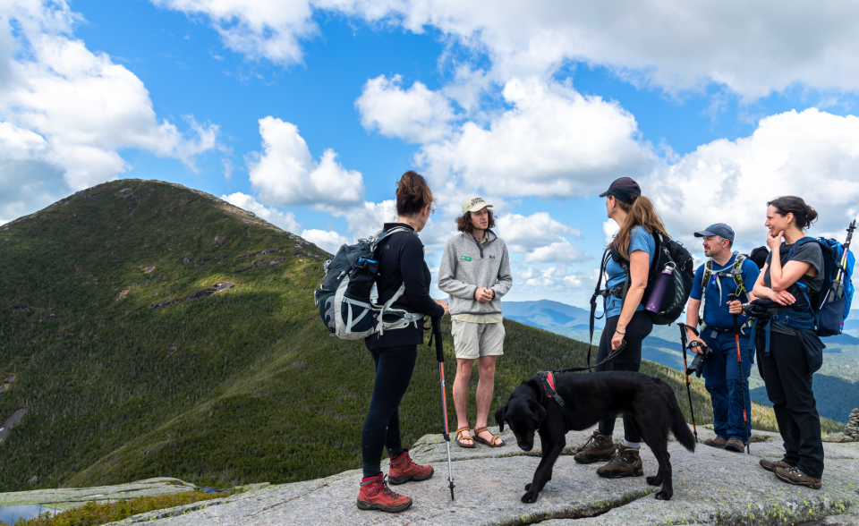 Mt. Algonquin looms in the background as hikers listen to an ADK Mountain Club summit steward speak about climate change.