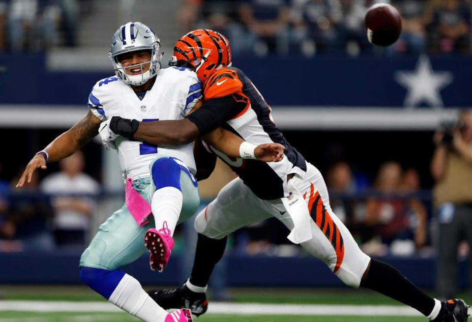 Dak Prescott #4 of the Dallas Cowboys is pressured by Carlos Dunlap #96 of the Cincinnati Bengals during the second quarter at AT&T Stadium on October 9, 2016 in Arlington, Texas. (Photo by Wesley Hitt/Getty Images)
