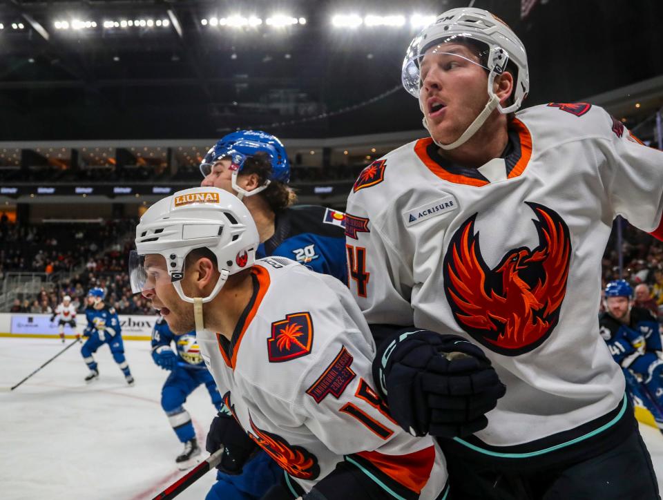 Coachella Valley forwards Carsen Twarynski (18, left) and Austin Poganski (14) look back toward their defenders during a play in the first period of their game at Acrisure Arena in Palm Desert, Calif., Wednesday, Jan. 4, 2023. 