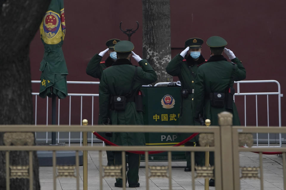 Chinese paramilitary policemen change shifts on the streets of Beijing near the Great Hall of the People on Wednesday, March 3, 2021. In a sign of confidence China has reverted back to holding its annual Congress meetings to march this year after delaying them due to the outbreak of the coronavirus last year. As usual, security has been tightened in the capital with paramilitary troops patrolling near the Great Hall of the People where the meetings are held and standing guard at subway stations. (AP Photo/Ng Han Guan)