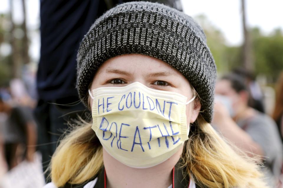 Jessica Linares, 19, joins a group of peaceful protesters as they gather at Curtis Hixon Park to demand justice for George Floyd and other victims police brutality on Sunday, May 31, 2020, in downtown Tampa. (Douglas R. Clifford/Tampa Bay Times via AP)