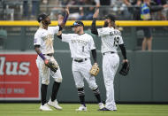 Colorado Rockies, from left, left fielder Raimel Tapia, center fielder Garrett Hampson and right fielder Charlie Blackmon celebrate after the ninth inning of a baseball game against the Arizona Diamondbacks Saturday, May 22, 2021, in Denver. The Rockies won 7-6. (AP Photo/David Zalubowski)