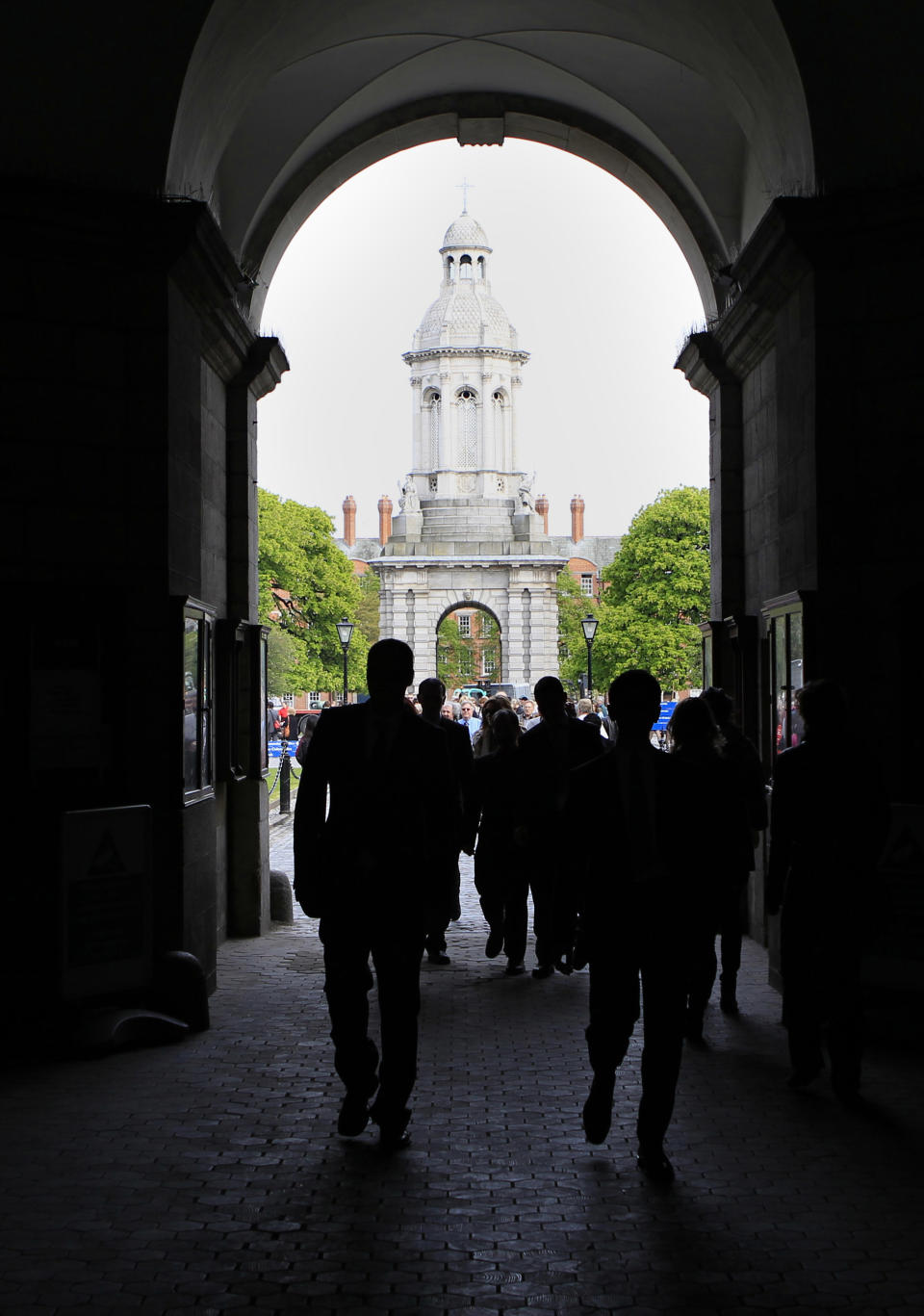 FILE - This April 9, 2011 file photo shows tourists visiting Trinity College in central Dublin, Ireland. Ireland is on many lists as a hotspot for travel in 2013 because of a grassroots homecoming event called "The Gathering," inviting those who are "Irish-born, Irish-bred and Irish in spirit" to visit. (AP Photo/Peter Morrison, file)