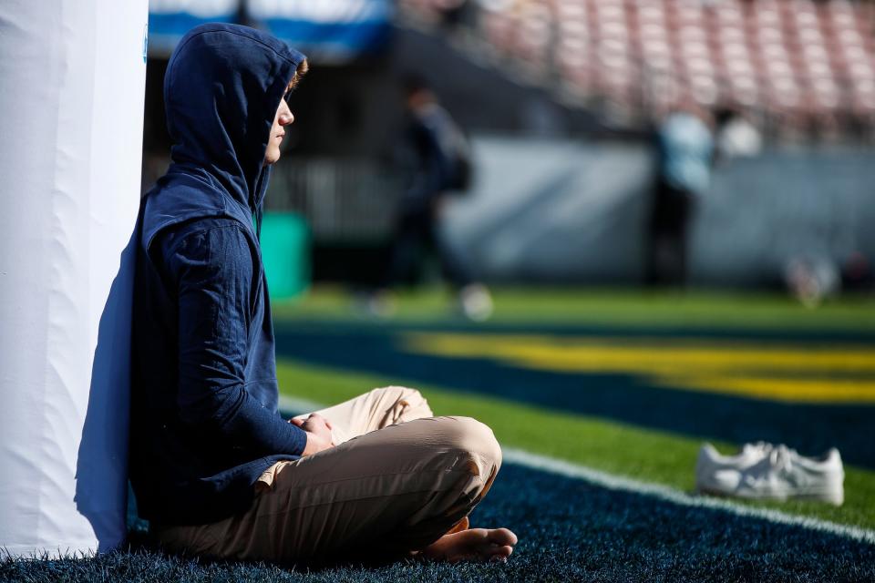 Michigan quarterback J.J. McCarthy meditates in the end zone during warmups before the Alabama game at Rose Bowl Stadium in Pasadena, California. on Monday, Jan. 1, 2024.