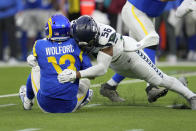 Los Angeles Rams quarterback John Wolford (13) is sacked by Seattle Seahawks linebacker Jordyn Brooks (56) for a 10-yard loss during the second half of an NFL football game Sunday, Dec. 4, 2022, in Inglewood, Calif. (AP Photo/Marcio Jose Sanchez)