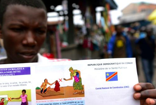 A man holds a Congolese health ministry leaflet on Ebola. Source: AFP