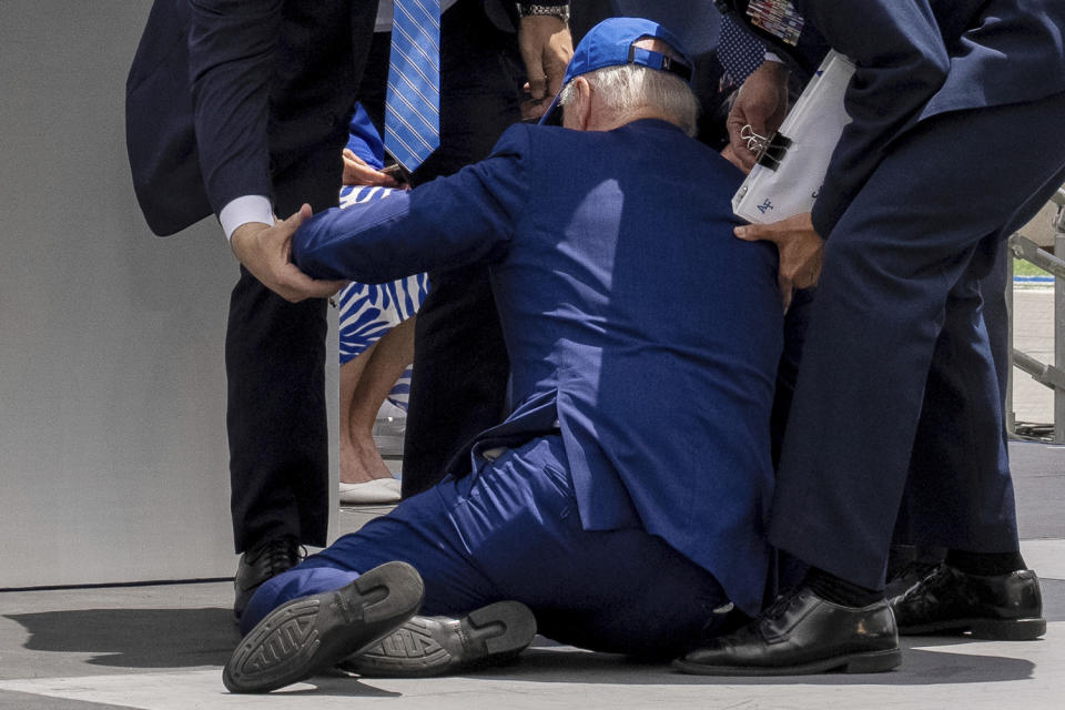 President Joe Biden falls on stage during the 2023 United States Air Force Academy Graduation Ceremony at Falcon Stadium, Thursday, June 1, 2023, at the United States Air Force Academy in Colorado Springs, Colo. (AP Photo/Andrew Harnik)