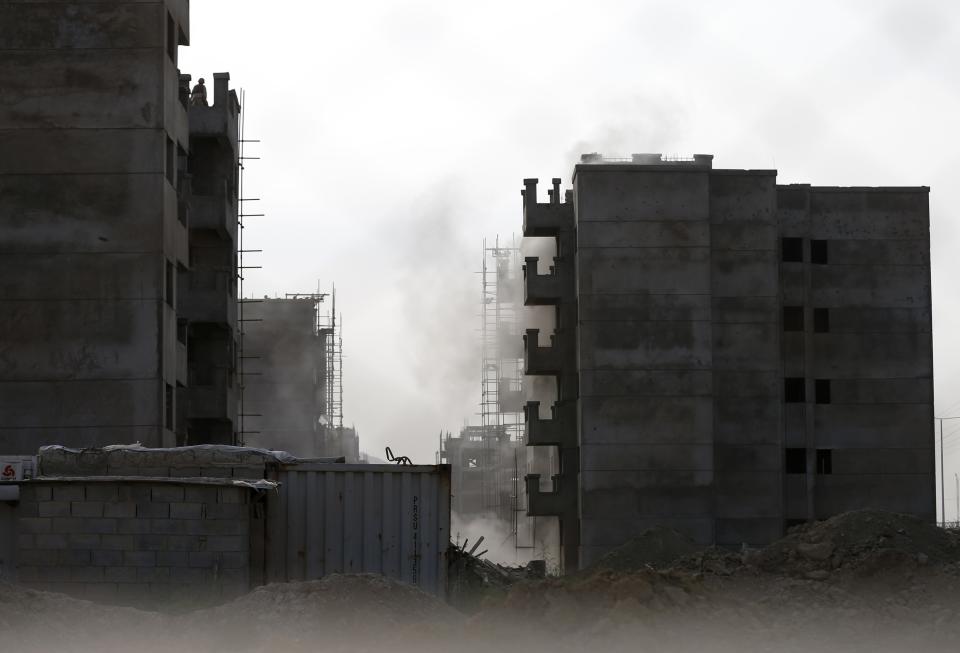 Smoke rises from a building where unidentified militants are located at, north of Kabul International Airport in Kabul