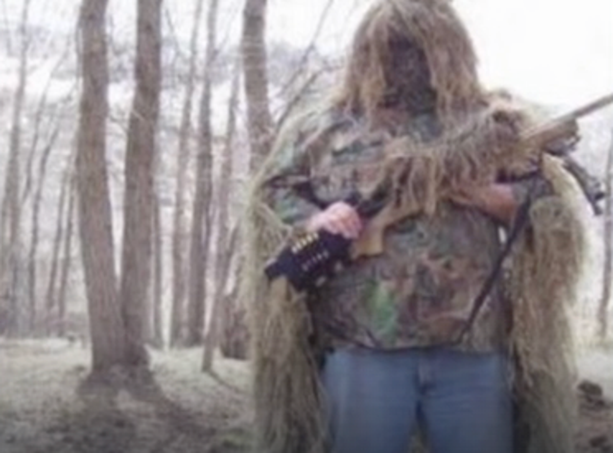 Craig Robertson stands in camouflage holding a rifle in an undated social media photo (US District Court)