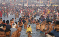 Devotees take holy dips at Sangam during Magh Mela festival, in Prayagraj, India. Tuesday, Feb.16, 2021. Millions of people have joined a 45-day long Hindu bathing festival in this northern Indian city, where devotees take a holy dip at Sangam, the sacred confluence of the rivers Ganga, Yamuna and the mythical Saraswati. Here, they bathe on certain days considered to be auspicious in the belief that they be cleansed of all sins. (AP Photo/Rajesh Kumar Singh)