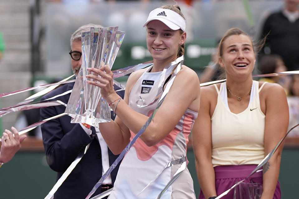 Elena Rybakina, of Kazakhstan, middle, celebrates after defeating Aryna Sabalenka, of Belarus, right, in the women's singles final at the BNP Paribas Open tennis tournament Sunday, March 19, 2023, in Indian Wells, Calif. (AP Photo/Mark J. Terrill)