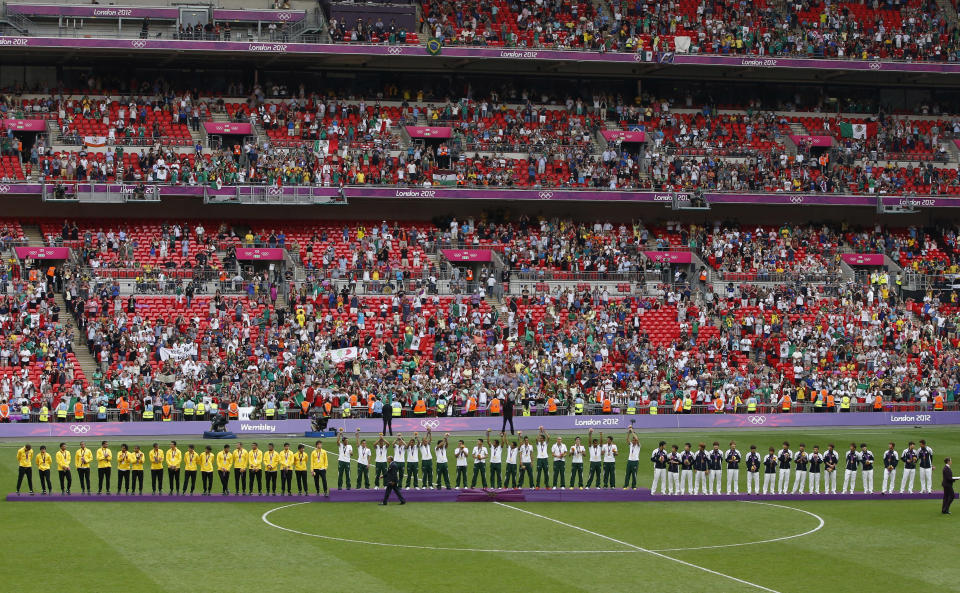 (L to R) Silver medallists Brazil, gold medallists Mexico and bronze medallists South Korea stand on the medal podiums during the soccer medal award ceremony at Wembley Stadium during the London 2012 Olympic Games August 11, 2012. REUTERS/Paul Hanna (BRITAIN - Tags: SPORT SOCCER OLYMPICS) 