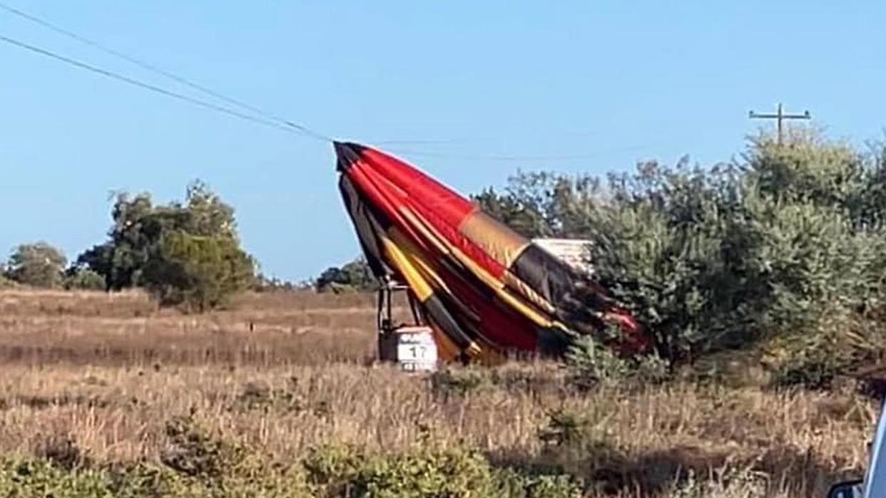 Two people were rescued when a hot air balloon struck power lines in rural NSW.