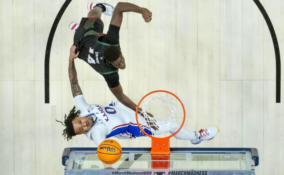 Kansas guard Bobby Pettiford Jr. (0) goes up against Howard forward Ayodele Taiwo (14) during a first-round college basketball game in the NCAA Tournament Thursday, March 16, 2023, in Des Moines, Iowa.