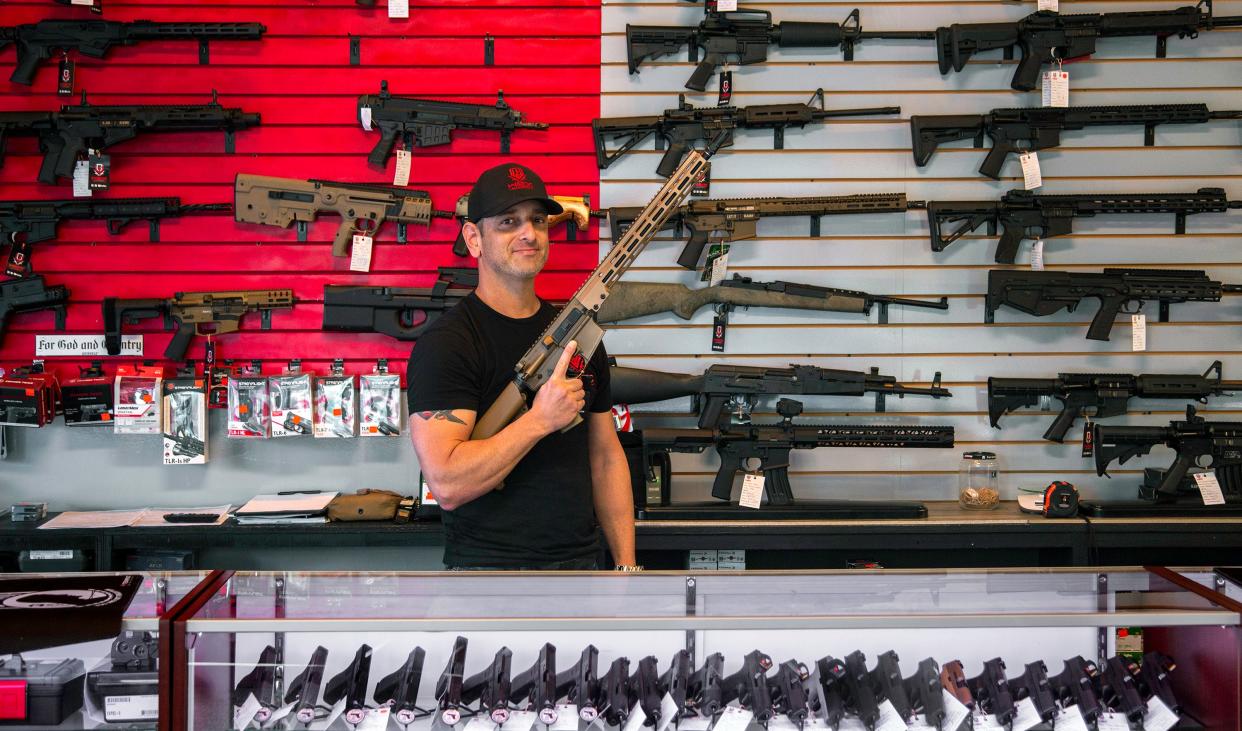 Semiautomatic rifles similar to the firearms that Delray Beach gun dealer Brandon Wexler had in this 2021 photo at his business, Wex Gunworks, were the kind of weapons prosecutors have said could be illegally converted into machine guns.