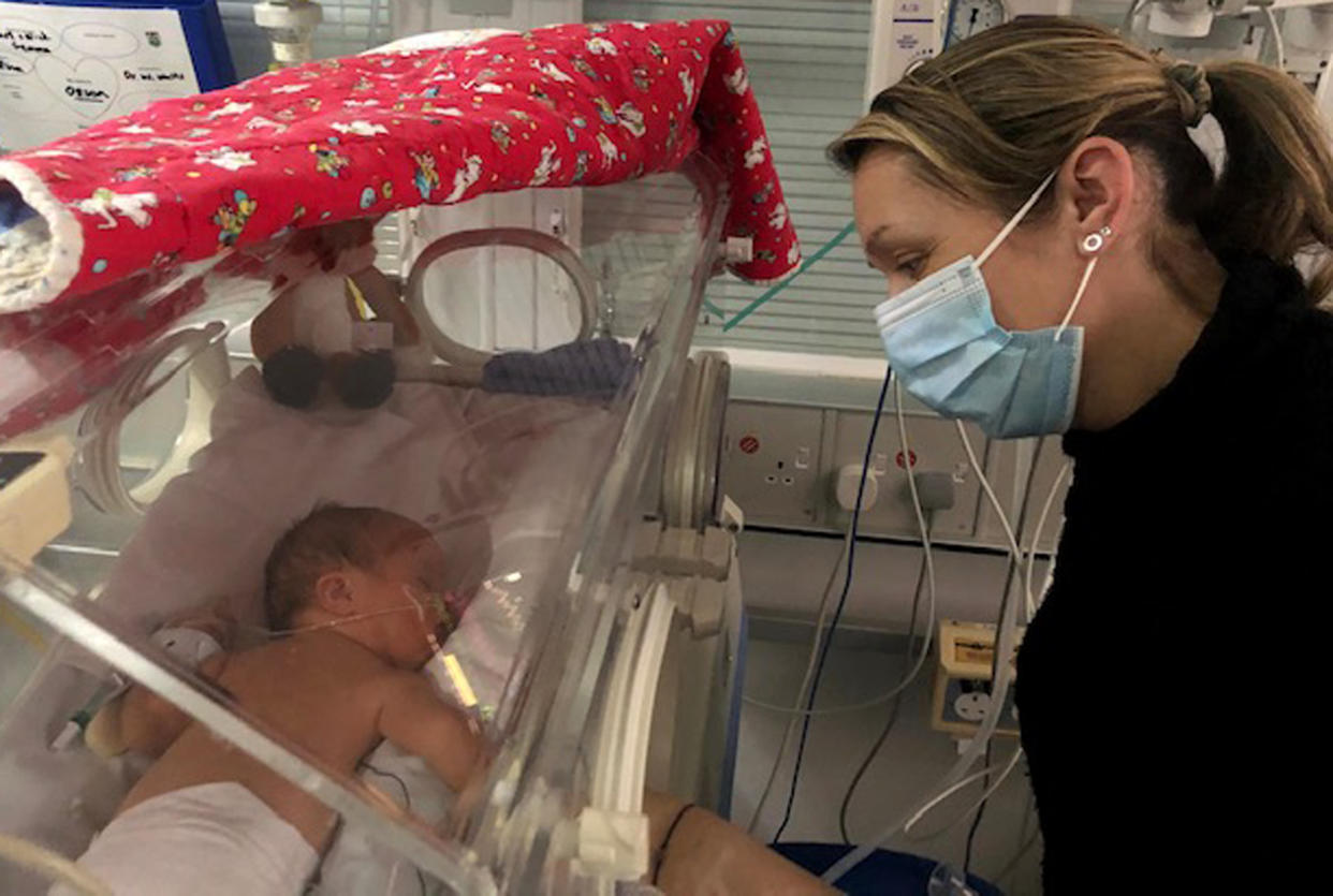 Olliman with her fourth surrogate baby, Orson, after an emergency C-section at 37 weeks. (Caters)