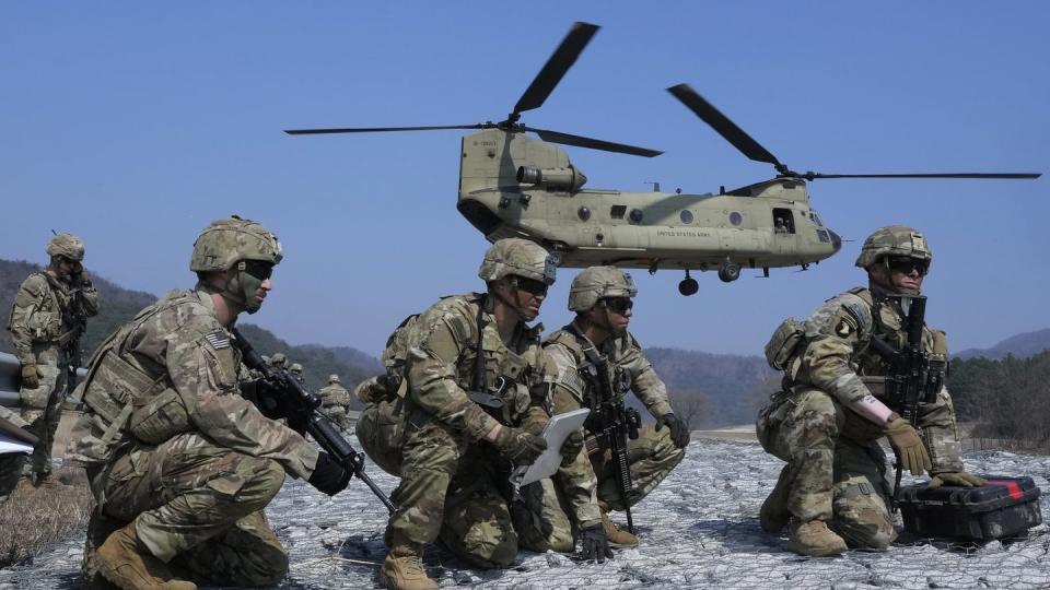 U.S. Army soldiers wait to board their CH-47 Chinook helicopter during a joint military drill between South Korea and the United States at Rodriguez Live Fire Complex in Pocheon, South Korea, Sunday, March 19, 2023. (Ahn Young-joon/AP)