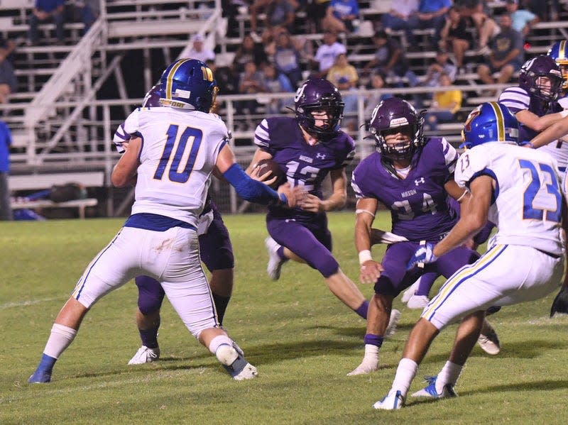 Mason High School's Ryne Todd (12) runs with the ball while Jaden Scantlin (34) provides blocking during a nondistrict high school football game against Comfort Friday, Sept. 3, 2021, at R. Clinton Schulze Stadium in Mason.