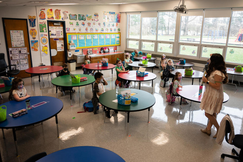 Students and a teacher in a socially distanced classroom at Medora Elementary School on March 17, 2021 in Louisville, Kentucky, as Jefferson County Public Schools reopened for in-person learning with new COVID-19 procedures in place. / Credit: Getty Images