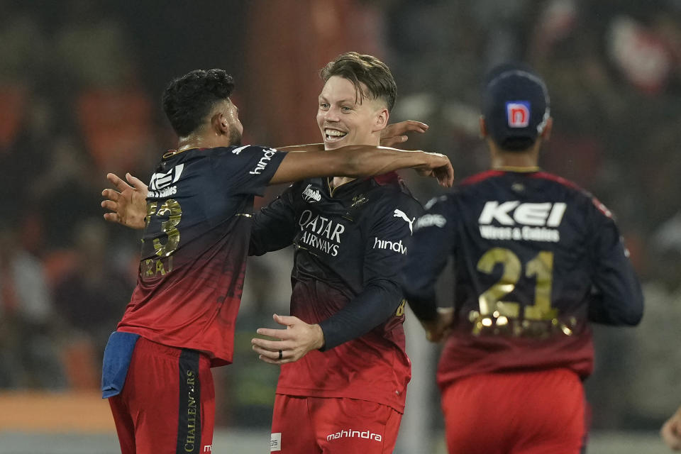 Royal Challengers Bangalores' Michael Bracewell, center, celebrates the wicket of Sunrisers Hyderabads' Abhishek Sharma during the Indian Premier League cricket match between Sunrisers Hyderabad and Royal Challengers Bangalore in Hyderabad, India, Thursday, May 18, 2023. (AP Photo/Mahesh Kumar A.)