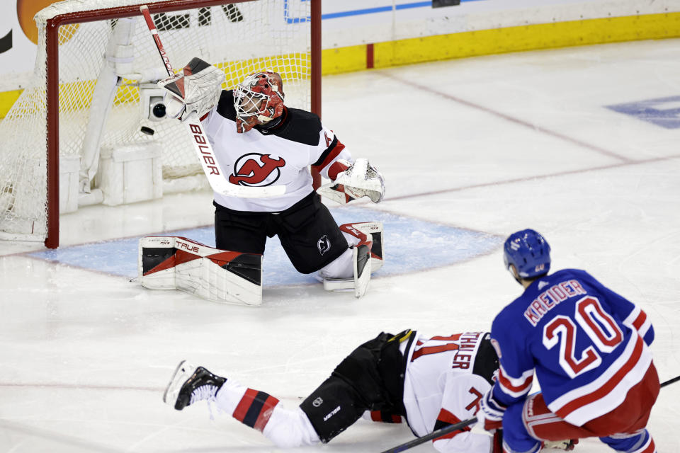 New York Rangers left wing Chris Kreider (20) scores a goal past New Jersey Devils goaltender Akira Schmid in the second period of Game 3 of the team's NHL hockey Stanley Cup first-round playoff series Saturday, April 22, 2023, in New York. (AP Photo/Adam Hunger)