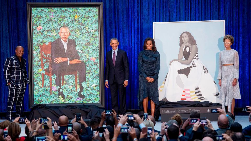 Former US President Barack Obama and First Lady Michelle Obama stand before their portraits and respective artists, Kehinde Wiley (L) and Amy Sherald (R), after an unveiling at the Smithsonian's National Portrait Gallery in Washington, DC, February 12, 2018