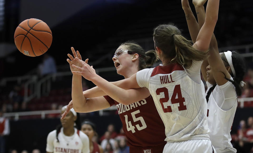 Washington State forward Borislava Hristova (45) passes away from Stanford's Lacie Hull (24) and DiJonai Carrington, right, during the first half of an NCAA college basketball game Sunday, Jan. 20, 2019, in Stanford, Calif. (AP Photo/Ben Margot)